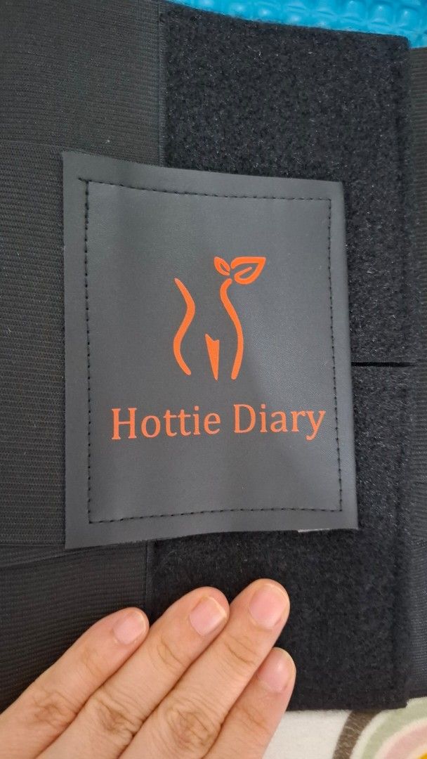Hottie Diary Waist Trainer Belt (Category: Undergarments & Loungewear) located in Paranaque City. Submitted by nylahtan (Listing ID 1461297572, Image 2). Description: - Brand: Hottie Diary - Color: Black - Type: Waist Trainer Belt - Closure: Adjustable velcro for a snug fit - Benefits: Helps with posture and shaping - Ideal for: Post-partum recovery or everyday wear - Dimensions: Approximately 11 inches in height.