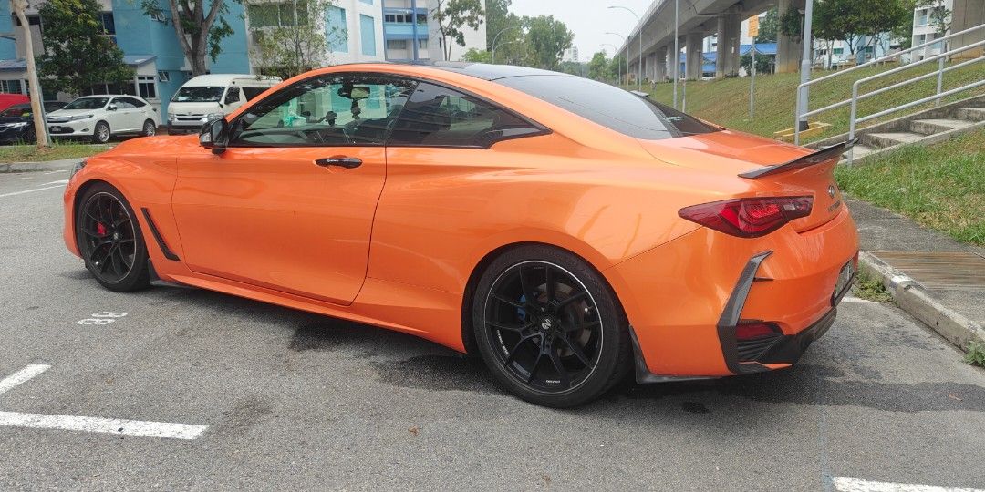 Infiniti Q60 2.0T (A) (Category: Used Cars) located in Singapore. Submitted by buys4fun (Listing ID 1459757243, Image 3). Description: Less than 10 cars in Singapore. Wear and tear parts have been replaced. comes with: New Orange wrap (Invictus) 19 inch sports rims BCBR Coilovers front BBK AMS Open port New engine mounts (3 mths old) New Wiper reservoir (3 mths old) Road Tax until 28 Dec 2026 Reason for selling: Need a four door with 3 rear passe