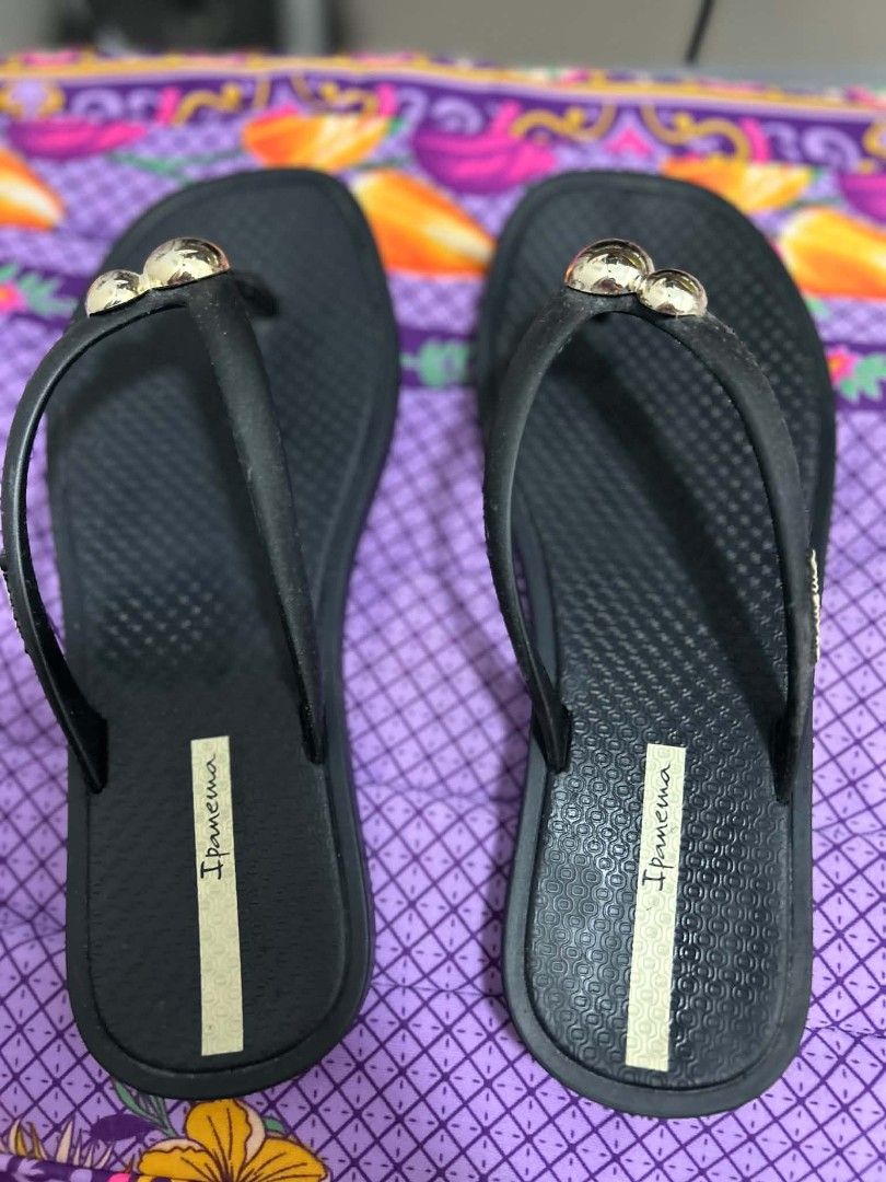 Ipanema Black Flip-flops with Gold Embellishments (Category: Slippers and slides) located in San Pablo. Submitted by anechka1823 (Listing ID 1461233422, Image 2). Description: - Brand: Ipanema - Color: Black - Size: 38 EUR - Design: Decorated with three gold balls on the strap - Features: Comfortable, easy to wear, wavy sole pattern for enhanced grip - Occasion: Ideal for casual outings.