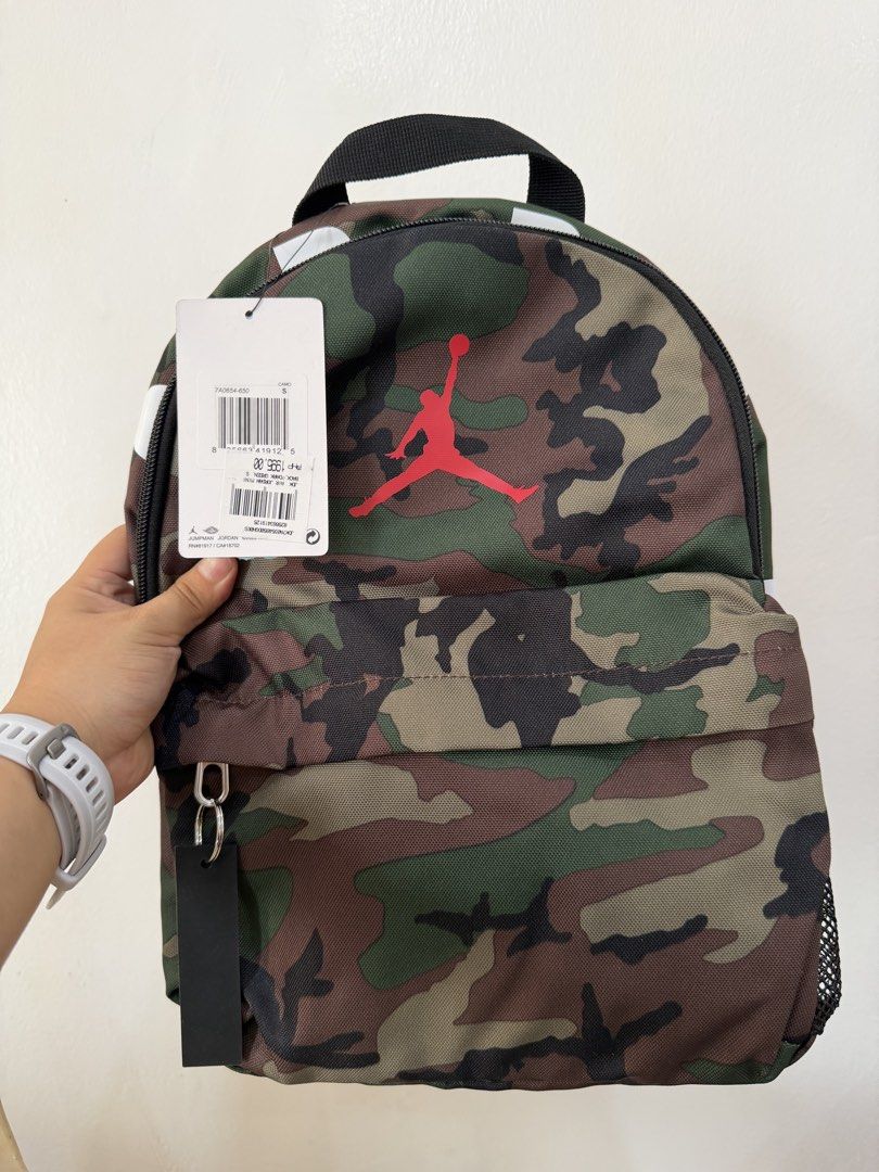 Jordan Camo Backpack (Category: Backpacks) located in Manila. Submitted by escarchame98247 (Listing ID 1461161988, Image 1). Description: - Stylish camouflage backpack - Features the iconic Jumpman logo - Includes a black tag - Convenient side mesh pocket - Ideal for school or everyday adventures.