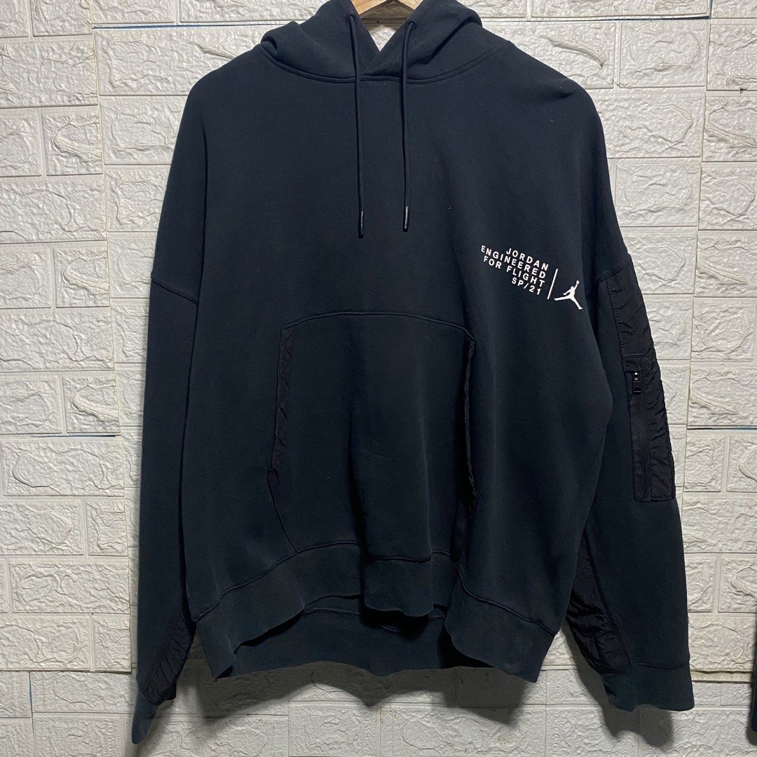 Jordan Engineered For Flight SP/21 Black Hoodie (Category: Coats, Jackets and Outerwear) located in Naga. Submitted by thesource4400 (Listing ID 1461291895, Image 1). Description: - Authentic Black Jordan hoodie from the SP/21 collection. - Front features 'Engineered For Flight' graphic and Jumpman logo. - Back showcases a large '23' graphic with Michael Jordan in action. - Convenient zippered pockets on the sleeves. - Designed for comfort and st
