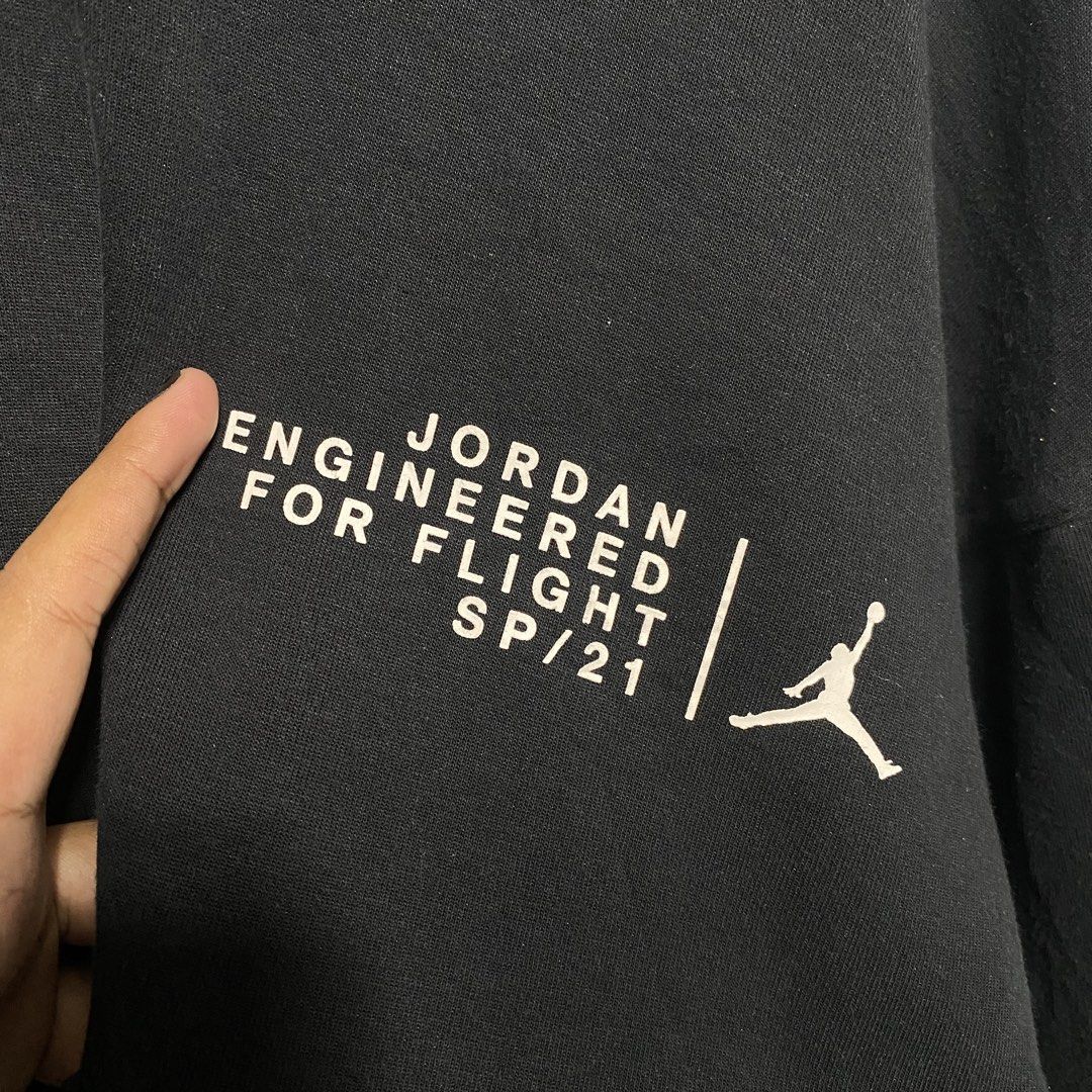 Jordan Engineered For Flight SP/21 Black Hoodie (Category: Coats, Jackets and Outerwear) located in Naga. Submitted by thesource4400 (Listing ID 1461291895, Image 3). Description: - Authentic Black Jordan hoodie from the SP/21 collection. - Front features 'Engineered For Flight' graphic and Jumpman logo. - Back showcases a large '23' graphic with Michael Jordan in action. - Convenient zippered pockets on the sleeves. - Designed for comfort and st