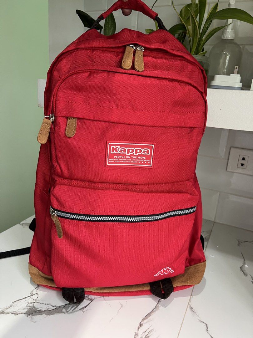 Kappa Back Pack with multiple pockets (Category: Backpacks) located in Cavite. Submitted by slumbermanila (Listing ID 1461260163, Image 1). Description: Kappa Back Pack with multiple pockets suede in bottom part and in puller with monogram logo in lining in nylon material in very good condition .