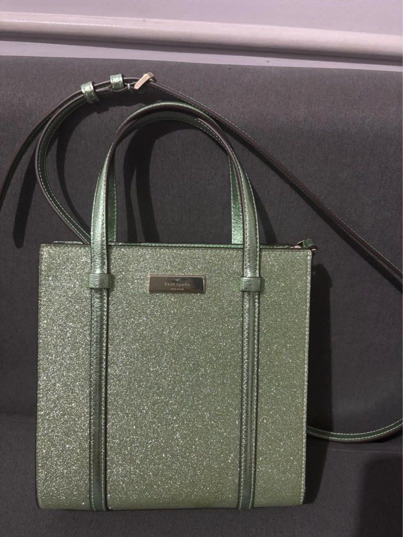 Kate Spade Glitter Tote Bag (Category: Tote Bags) located in Makati City. Submitted by staraby (Listing ID 1461121109, Image 1). Description: - Sparkly green Kate Spade tote bag - Features top handles and a long, adjustable strap - All-over glitter detailing for maximum shine - Iconic Kate Spade logo on a front metal plate - Adds a touch of glamour to any look.