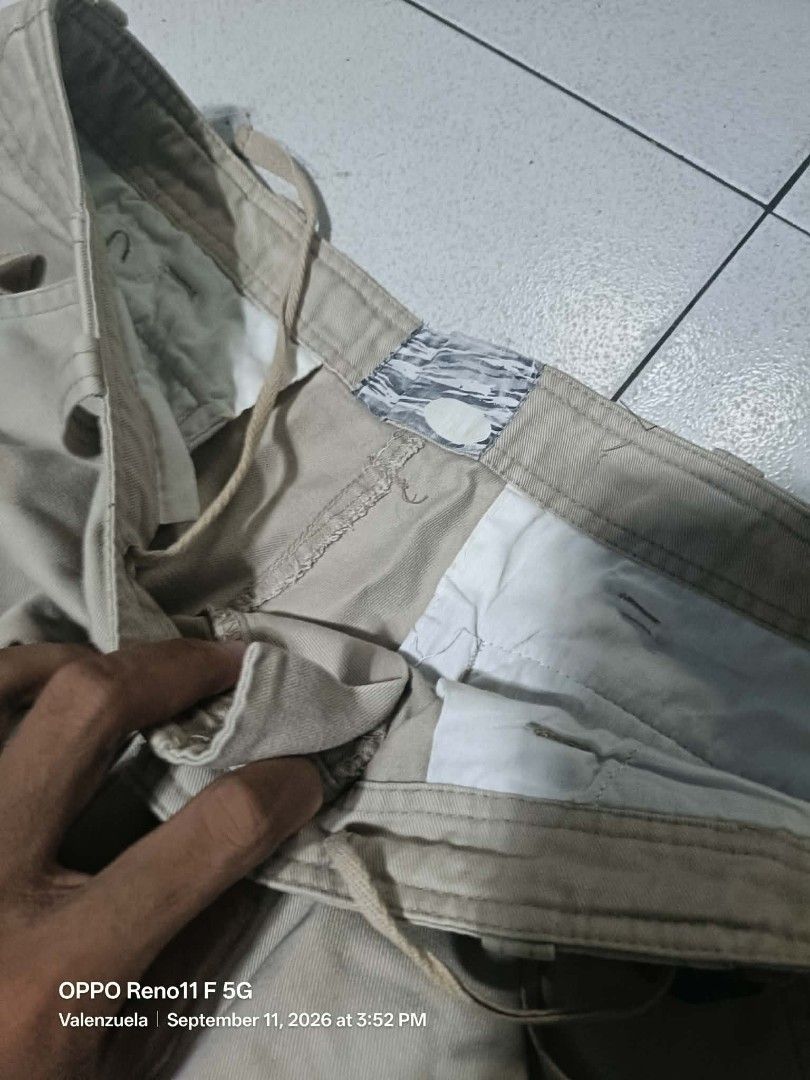 Khaki Cargo Pants - Zip-off Legs (Category: Joggers) located in Valenzuela. Submitted by thrift_ko_cedie222 (Listing ID 1461155147, Image 2). Description: - Khaki cargo pants - Zip-off legs convert to shorts - Multiple storage pockets - Drawstring waist for adjustable fit - Ideal for outdoor activities and casual wear - Please note: some stitching is coming undone near the crotch area.