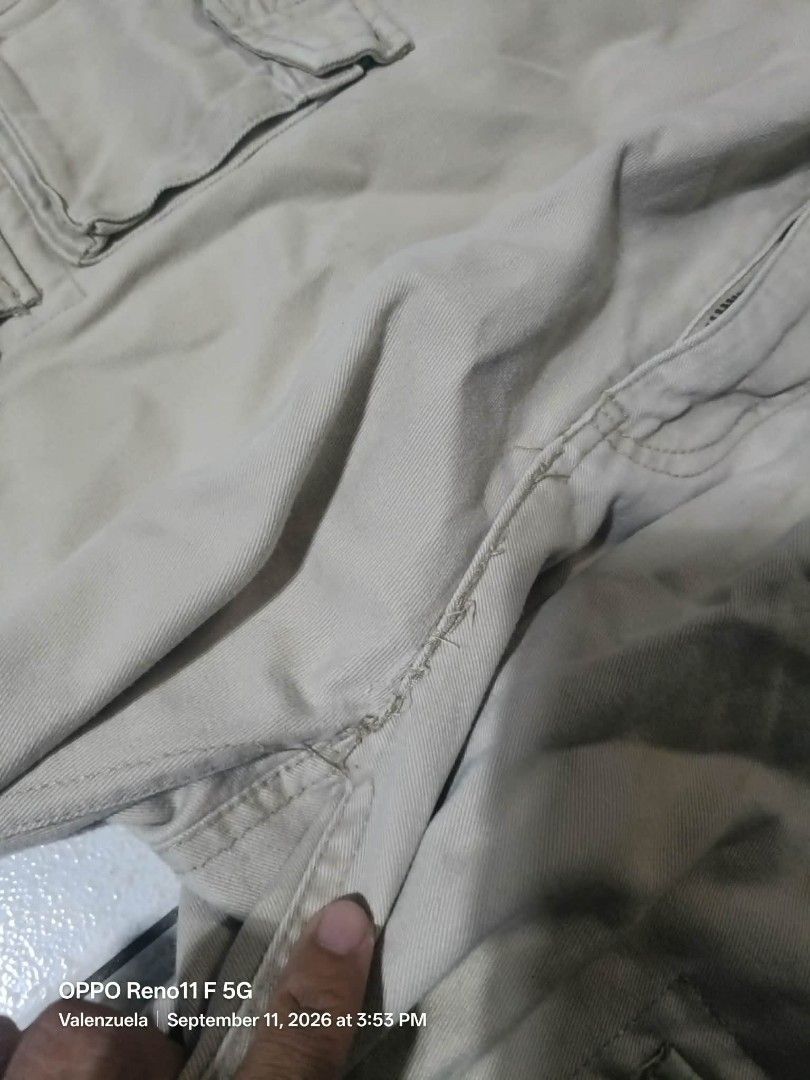 Khaki Cargo Pants - Zip-off Legs (Category: Joggers) located in Valenzuela. Submitted by thrift_ko_cedie222 (Listing ID 1461155147, Image 3). Description: - Khaki cargo pants - Zip-off legs convert to shorts - Multiple storage pockets - Drawstring waist for adjustable fit - Ideal for outdoor activities and casual wear - Please note: some stitching is coming undone near the crotch area.