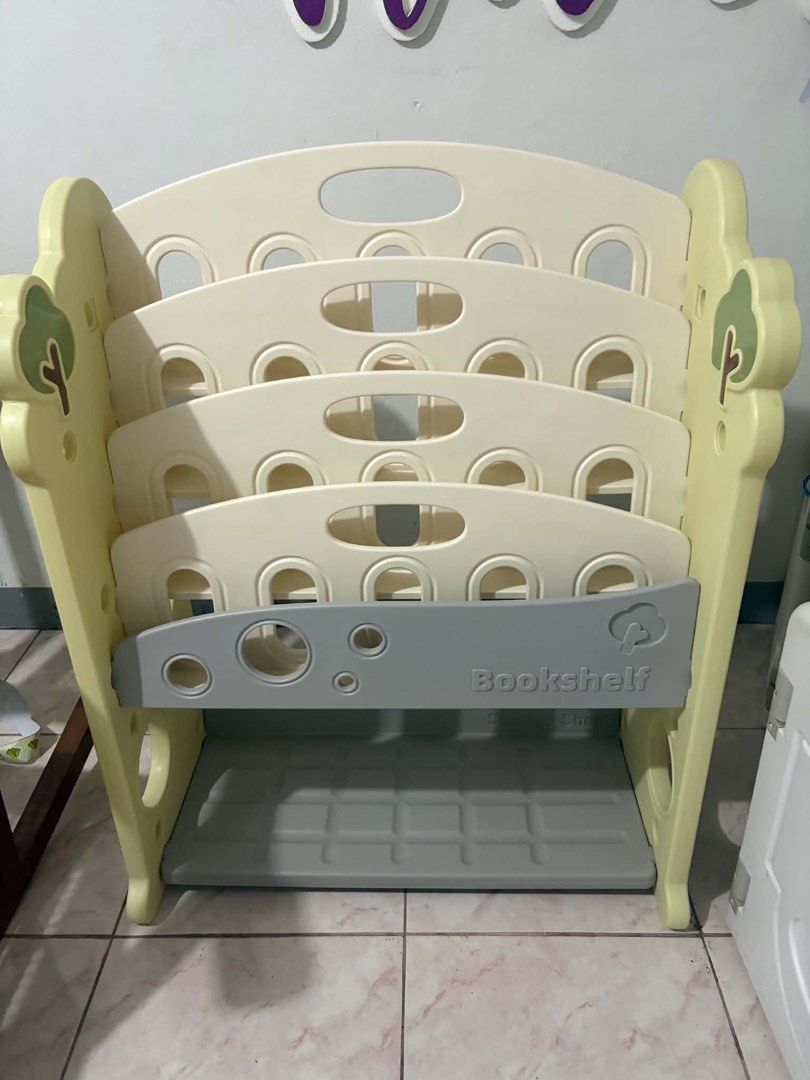 Kids Bookshelf 4 Tier Plastic Storage Organizer (Category: Shelves, Cabinets & Racks) located in Dagupan City. Submitted by pettykat (Listing ID 1461192932, Image 1). Description: - Cute 4-tier bookshelf for kids - Made of durable plastic - Features fun tree designs on the sides - Bottom shelf labeled 'Bookshelf' - Ideal for organizing books and toys - Easy to clean.