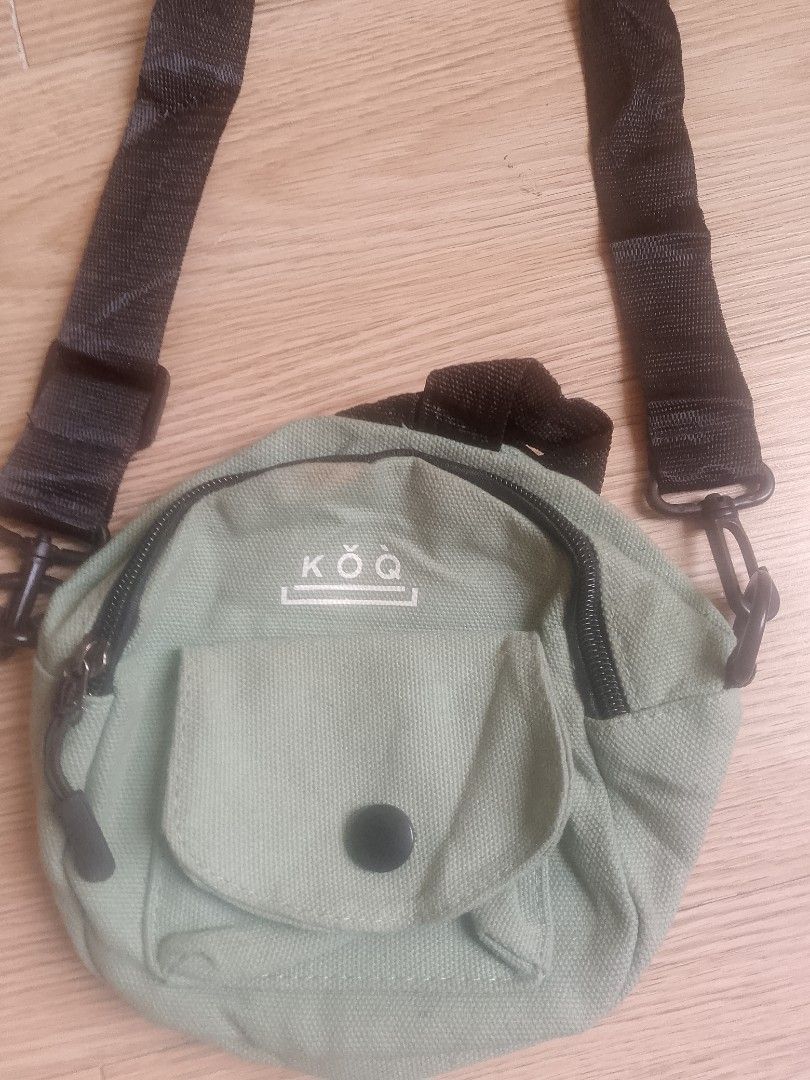 KOQ Canvas Crossbody Bag - Light Green (Category: Sling Bags) located in Santa Rosa. Submitted by 3kthriftstore (Listing ID 1461276113, Image 2). Description: - Cute light green canvas crossbody bag from KOQ. - Main zip compartment for secure storage. - Front pocket with button closure for easy access. - Adjustable strap for a comfortable fit. - Small and compact, ideal for everyday use or travel. Condition 9/10.