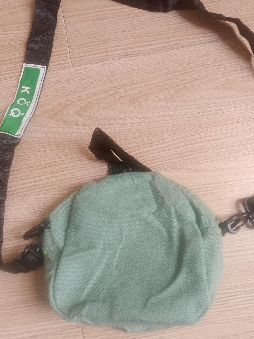 KOQ Canvas Crossbody Bag - Light Green (Category: Sling Bags) located in Santa Rosa. Submitted by 3kthriftstore (Listing ID 1461276113, Image 3). Description: - Cute light green canvas crossbody bag from KOQ. - Main zip compartment for secure storage. - Front pocket with button closure for easy access. - Adjustable strap for a comfortable fit. - Small and compact, ideal for everyday use or travel. Condition 9/10.