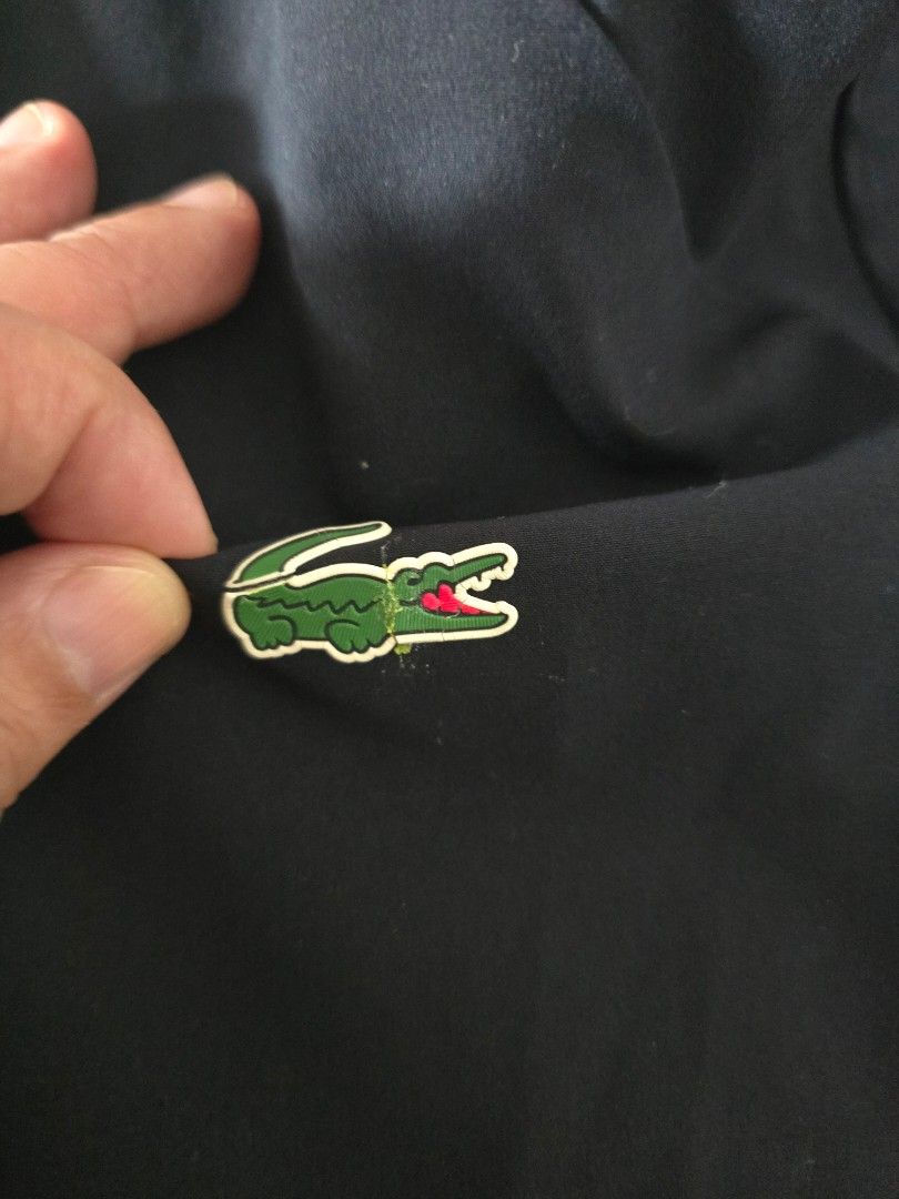 Lacoste Black Hooded Jacket (Category: Coats, Jackets and Outerwear) located in Pasig City. Submitted by yoyosstore (Listing ID 1461190457, Image 3). Description: Personal rain jacket not thrift. Bought bnew. material is stretch fabric like spandex, vwry comfortable. size 52 L - Black hooded jacket from Lacoste (raincoat) fully waterproof - Full zip closure - Iconic crocodile logo on the chest - Two side pockets - Ideal for casual wear or light o