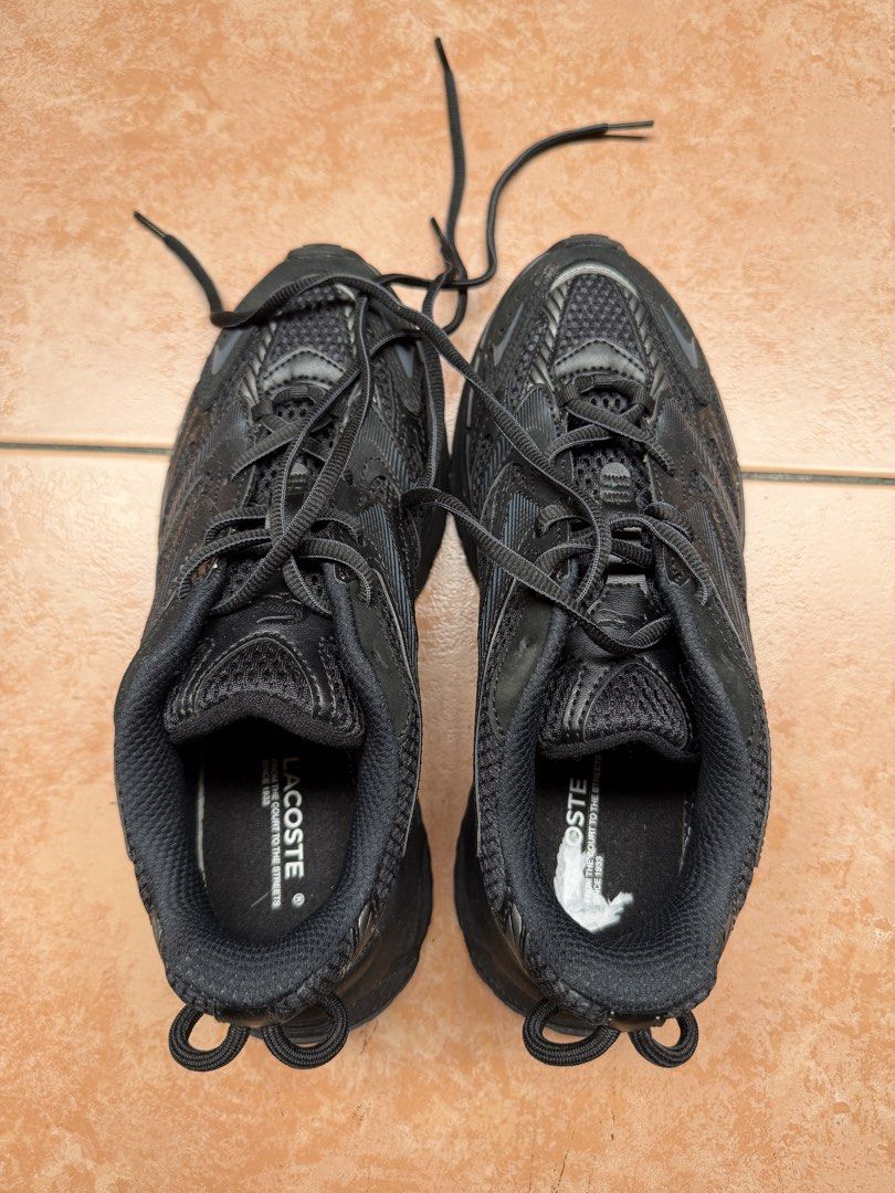 Lacoste Mens L003 Neo Shot (Category: Sneakers) located in Quezon City. Submitted by martaplur (Listing ID 1461246783, Image 2). Description: - Black Lacoste sneakers - Breathable mesh upper with synthetic overlays - Secure lace-up closure - Convenient pull tabs at the heel - Durable rubber outsole for excellent grip - Perfect for everyday wear and light activities.
