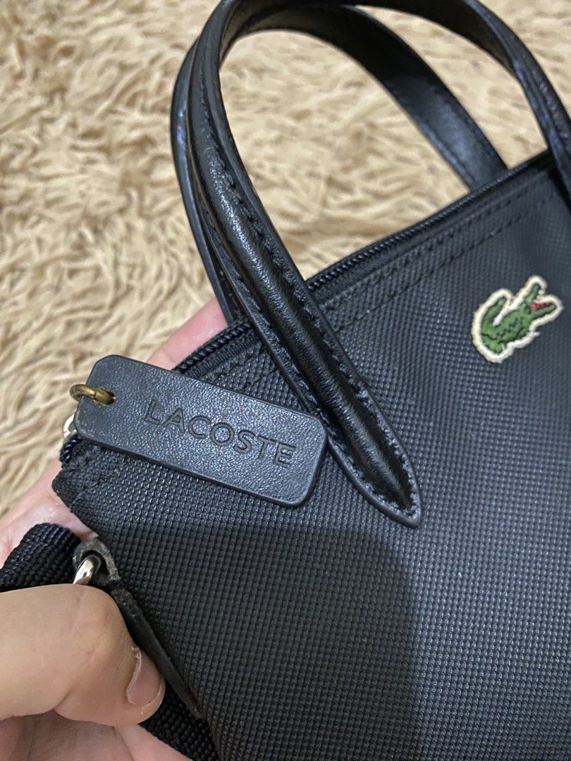Lacoste Mini L 12.12 Concept Tote Bag (Category: Luxury Bags & Wallets) located in Lucena. Submitted by catherineluces18 (Listing ID 1461282781, Image 3). Description: 8"inch (width) 6.5"inch (length) highlights: •color black •top handle •adjustable shoulder strap • textured finish • no flaws • need wash only • main compartment.