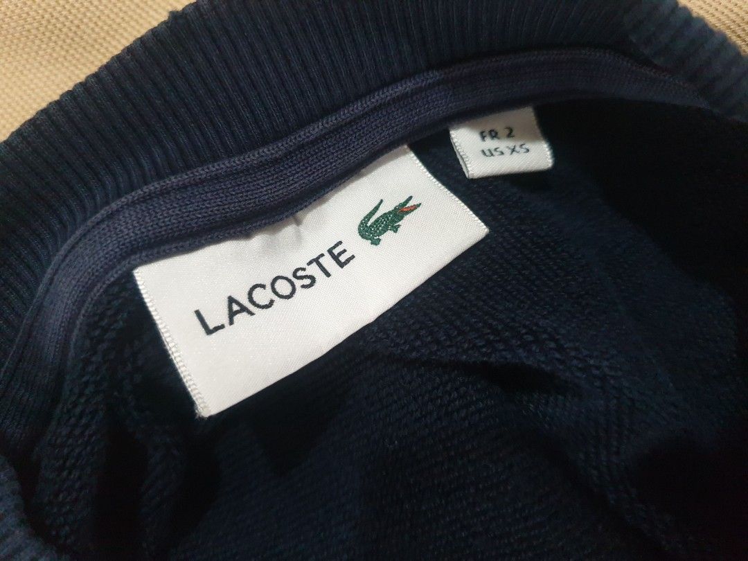 Lacoste navy blue crewneck sweatshirt (Category: Coats, Jackets and Outerwear) located in Paranaque City. Submitted by nvdluxurygoods (Listing ID 1461219060, Image 3). Description: This is a dark navy blue Lacoste crewneck sweatshirt featuring a large outline embroidered crocodile logo on the chest. ready to ship maganda 10/10 no flaws, no issue.