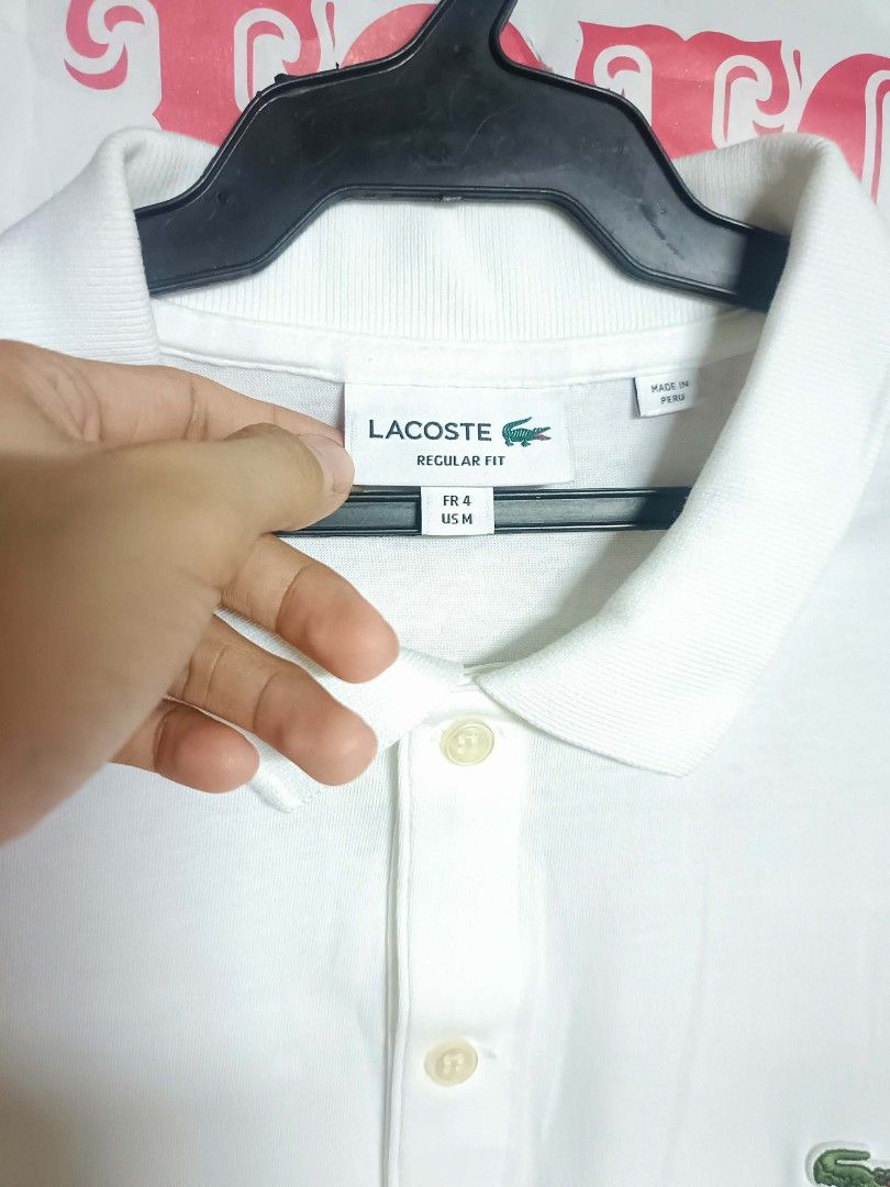 Lacoste Regular Fit White Polo Shirt (Category: Tshirts & Polo Shirts ) located in Makati City. Submitted by elgamapenumbra (Listing ID 1461179958, Image 3). Description: - White Lacoste Polo Shirt - Size: US Medium / French 4 - Fit: Regular - Origin: Made in Peru - Features: Iconic crocodile logo - Style: Versatile for casual or smart-casual wear.