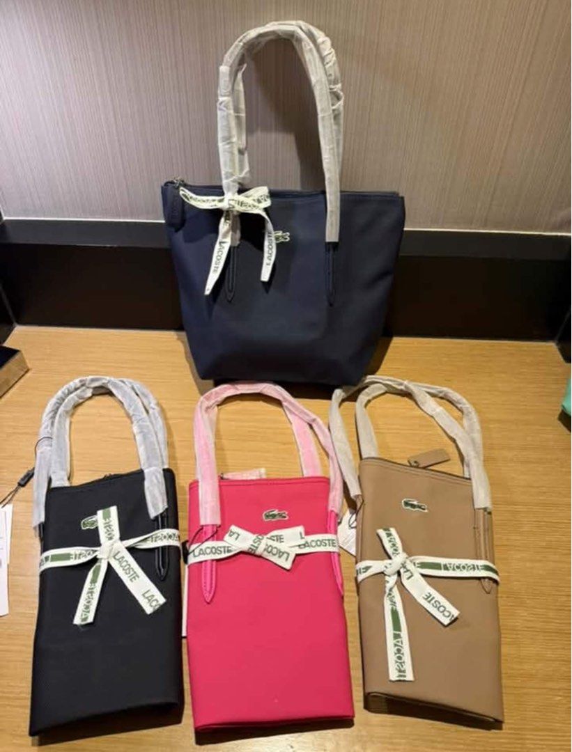 Lacoste Tote Bags - Multiple Colors Available (Category: Tote Bags) located in Marikina City. Submitted by bry_lei26 (Listing ID 1461139481, Image 1). Description: - Set of 4 Lacoste tote bags - Includes 1 large navy blue bag - Includes 3 smaller bags in black, hot pink, and tan - All bags feature elegant ribbon details - Iconic Lacoste crocodile logo on each bag - Handles are wrapped in protective plastic for pristine condition - Ideal for every