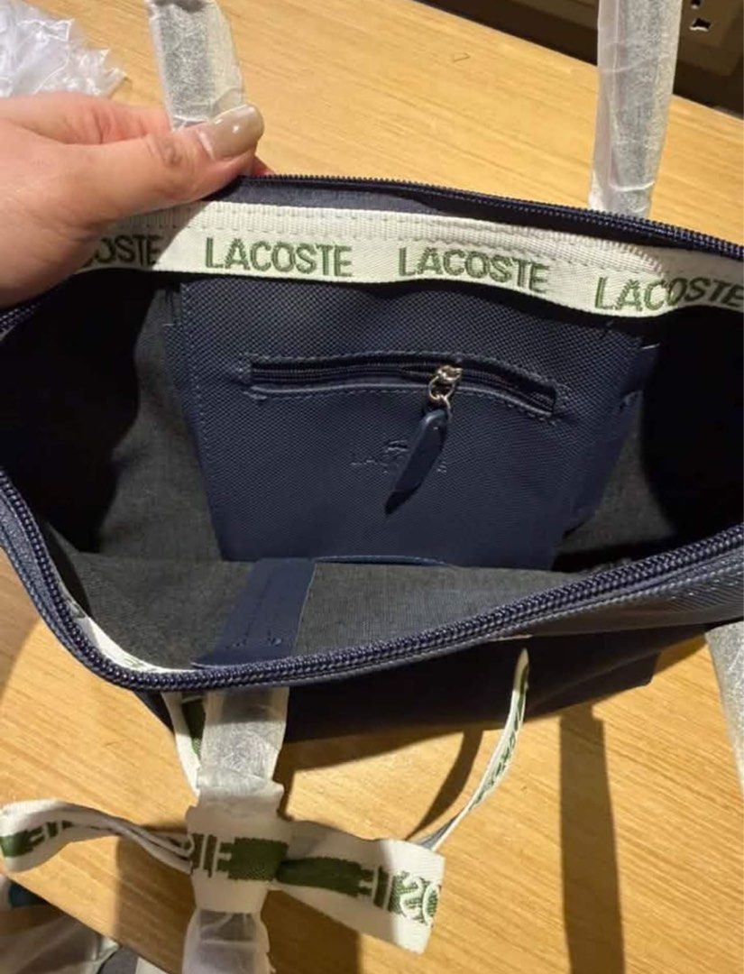 Lacoste Tote Bags - Multiple Colors Available (Category: Tote Bags) located in Marikina City. Submitted by bry_lei26 (Listing ID 1461139481, Image 2). Description: - Set of 4 Lacoste tote bags - Includes 1 large navy blue bag - Includes 3 smaller bags in black, hot pink, and tan - All bags feature elegant ribbon details - Iconic Lacoste crocodile logo on each bag - Handles are wrapped in protective plastic for pristine condition - Ideal for every