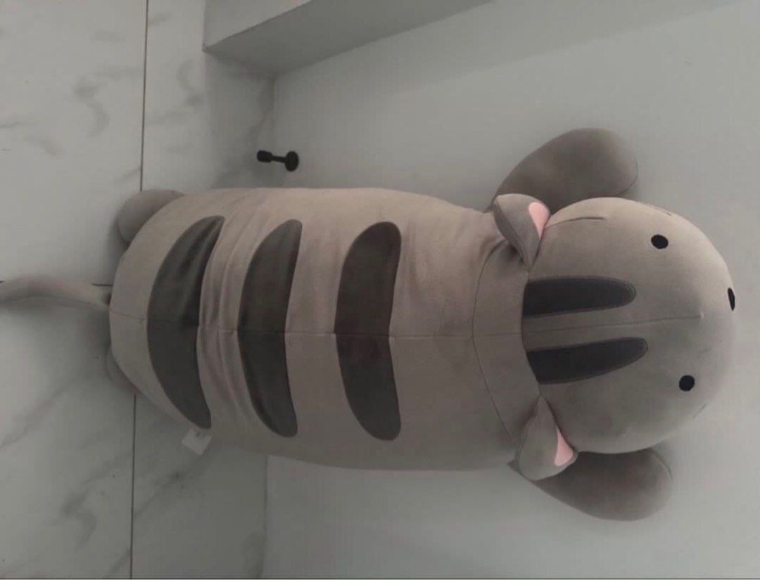 Large Grey Cat Plush Pillow Toy (Category: Plushies & Soft Toys) located in Manila. Submitted by decluterthings888 (Listing ID 1461138059, Image 1). Description: - Super cute and squishy grey cat plush pillow - Great for cuddling or as a decorative piece - Large size, perfect for lounging - Features nice stripe details - Comes from a clean, smoke-free home - Ready for a new owner!.