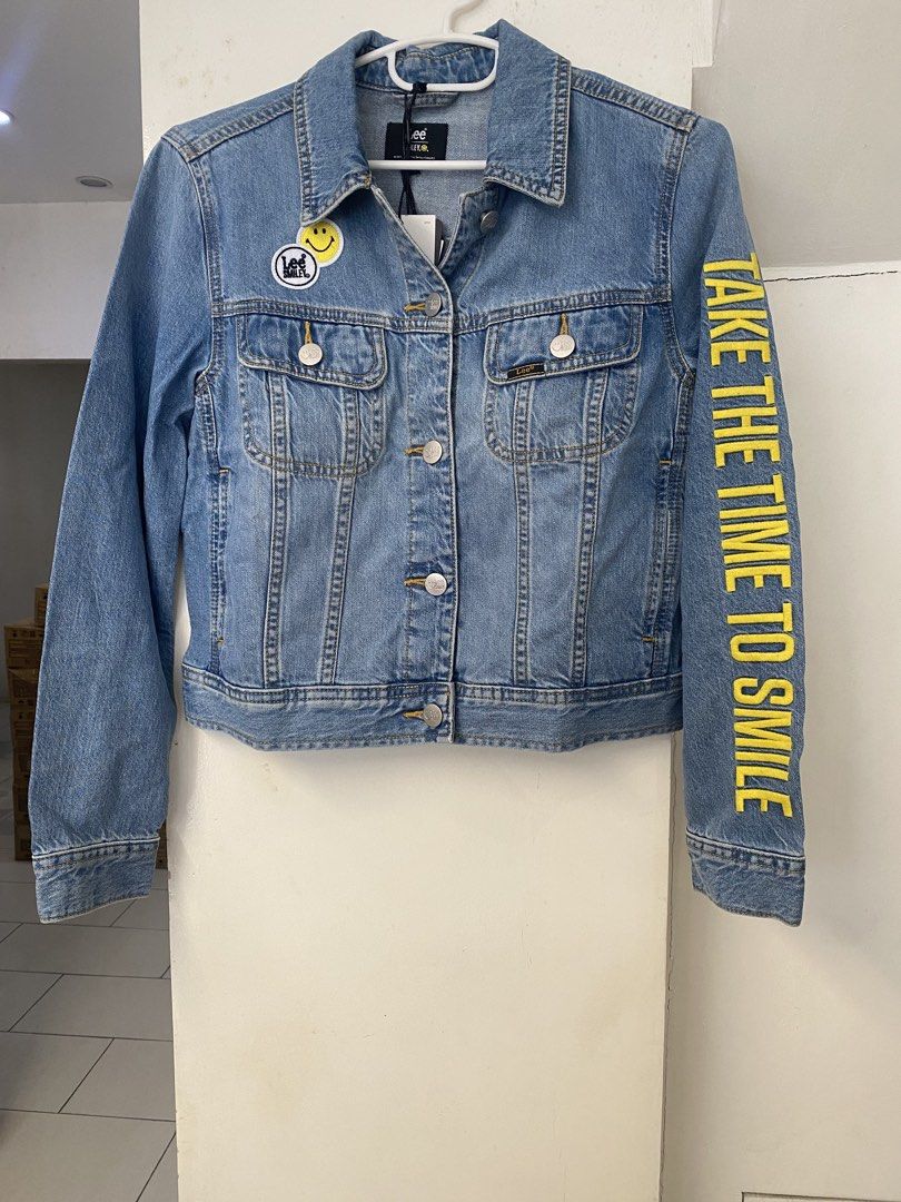 Lee x Smiley Collaboration Denim Jacket XS (Category: Coats, Jackets and Outerwear) located in Mandaluyong City. Submitted by streetchicstyle (Listing ID 1461145558, Image 1). Description: - Authentic Lee denim jacket with exclusive Smiley collaboration. - Iconic Smiley face logo prominently displayed on the back. - Features 'Take the Time to Smile' text detail on the sleeve. - Perfect for adding a playful and stylish touch to any outfit. - made 