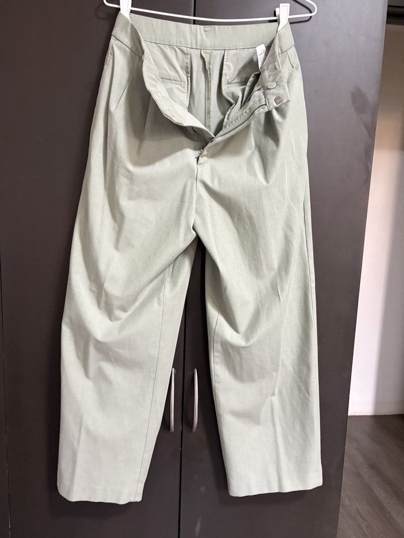 Light Green Wide Leg Trousers (Category: Other Bottoms) located in Las Pinas. Submitted by beissmart (Listing ID 1461190458, Image 1). Description: - Light green wide-leg trousers - Front zip and button closure - Subtle textured fabric - Versatile for casual and smart casual outfits - Easy to pair with various tops.