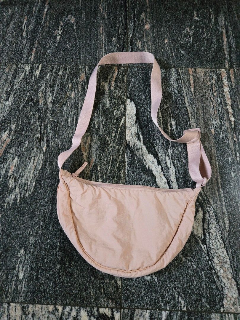 Light Pink Crescent Crossbody Bag (Category: Cross-body Bags) located in Las Pinas. Submitted by juliagarcia95 (Listing ID 1461172453, Image 1). Description: - Cute light pink crescent bag - Main zippered compartment - Interior slip pockets - Adjustable strap - Ideal for carrying essentials - Versatile wear: crossbody or shoulder.