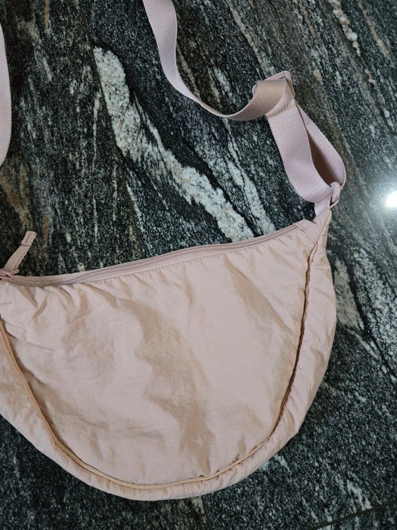Light Pink Crescent Crossbody Bag (Category: Cross-body Bags) located in Las Pinas. Submitted by juliagarcia95 (Listing ID 1461172453, Image 3). Description: - Cute light pink crescent bag - Main zippered compartment - Interior slip pockets - Adjustable strap - Ideal for carrying essentials - Versatile wear: crossbody or shoulder.