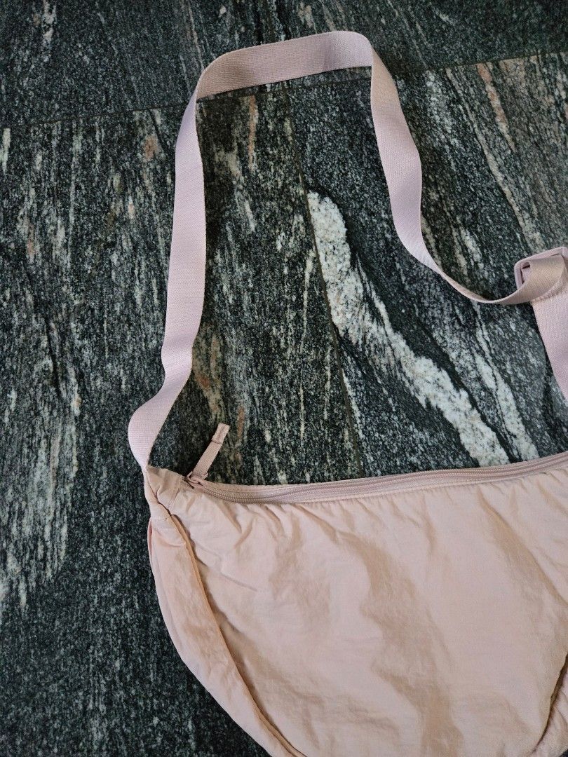 Light Pink Crescent Crossbody Bag (Category: Cross-body Bags) located in Las Pinas. Submitted by juliagarcia95 (Listing ID 1461172453, Image 2). Description: - Cute light pink crescent bag - Main zippered compartment - Interior slip pockets - Adjustable strap - Ideal for carrying essentials - Versatile wear: crossbody or shoulder.