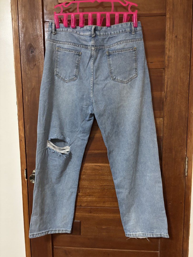 Light Wash Ripped Wide Leg Jeans (Category: Jeans) located in Trece Martires City. Submitted by decluttercloset_niks (Listing ID 1461230870, Image 2). Description: - Light wash denim - Ripped detail on one leg - Wide leg silhouette - Size XXL - Casual and trendy style.