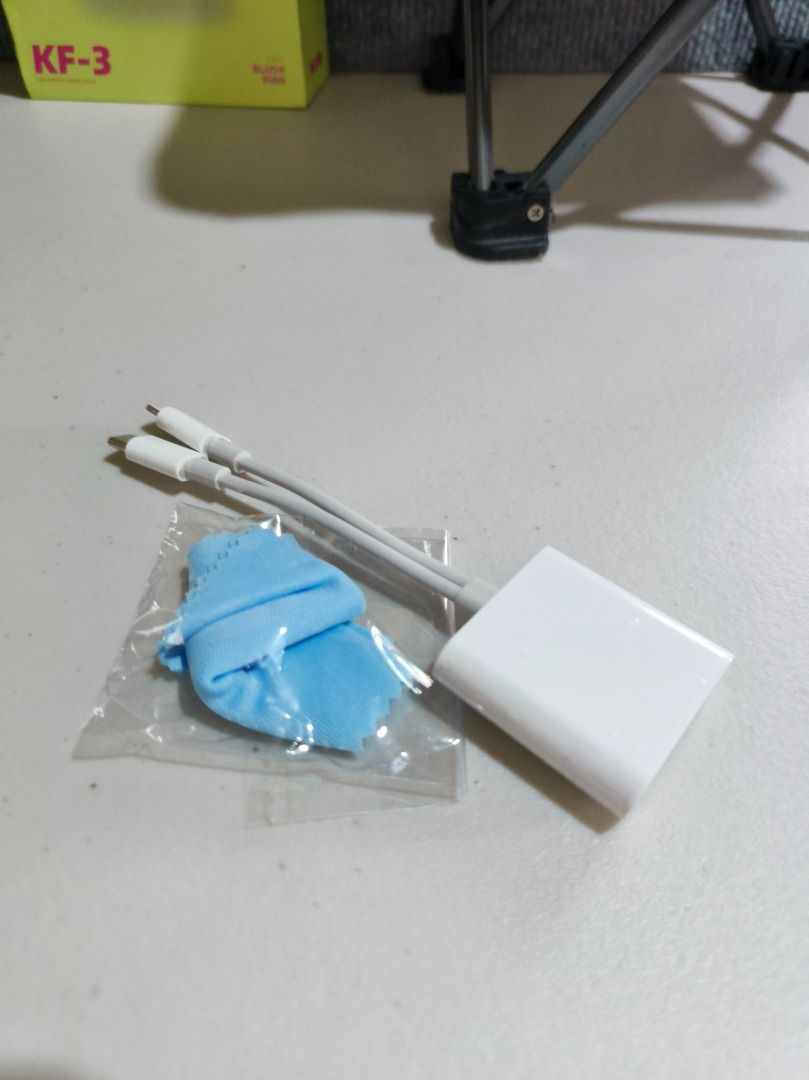 Lightning to SD Card Camera Reader Adapter with USB Hub (Category: Other Mobile & Gadget Accessories) located in San Leonardo. Submitted by burgossanleonardo.12345 (Listing ID 1461167859, Image 1). Description: - White adapter with 2 Lightning cables and a USB port. - SD card slots included. - Comes with a small blue cleaning cloth. - Easily transfer photos and videos from your camera or phone. - Plug and play, no drivers needed. - Perfect for on