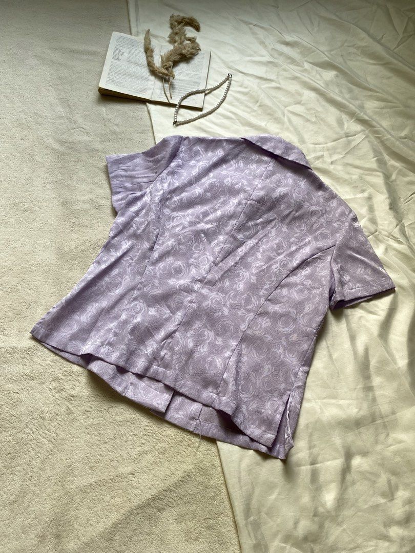 Lilac Floral Pattern Short Sleeve Button-Up Blouse Small-Med 37 (Category: Blouses) located in Poro. Submitted by joyceyuu (Listing ID 1461304092, Image 3). Description: - Light purple blouse - Subtle floral pattern - Short sleeves - Classic collar - Button-up front - Ideal for spring/summer outfits - Can be dressed up or down.