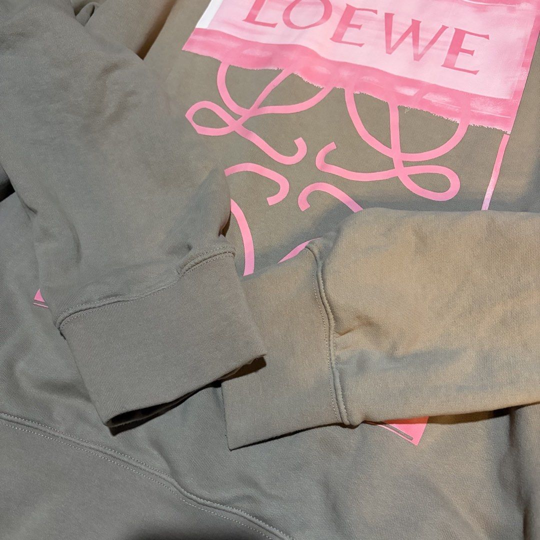 Loewe Anagram Logo Sweatshirt (Category: Luxury Apparel) located in Manila. Submitted by jhez_r.s (Listing ID 1461218647, Image 3). Description: - Authentic Loewe sweatshirt - Chic beige color - Features iconic pink Anagram logo - Classic crewneck design - Ribbed cuffs and hem for a comfortable fit - Ideal for stylish, casual outfits.