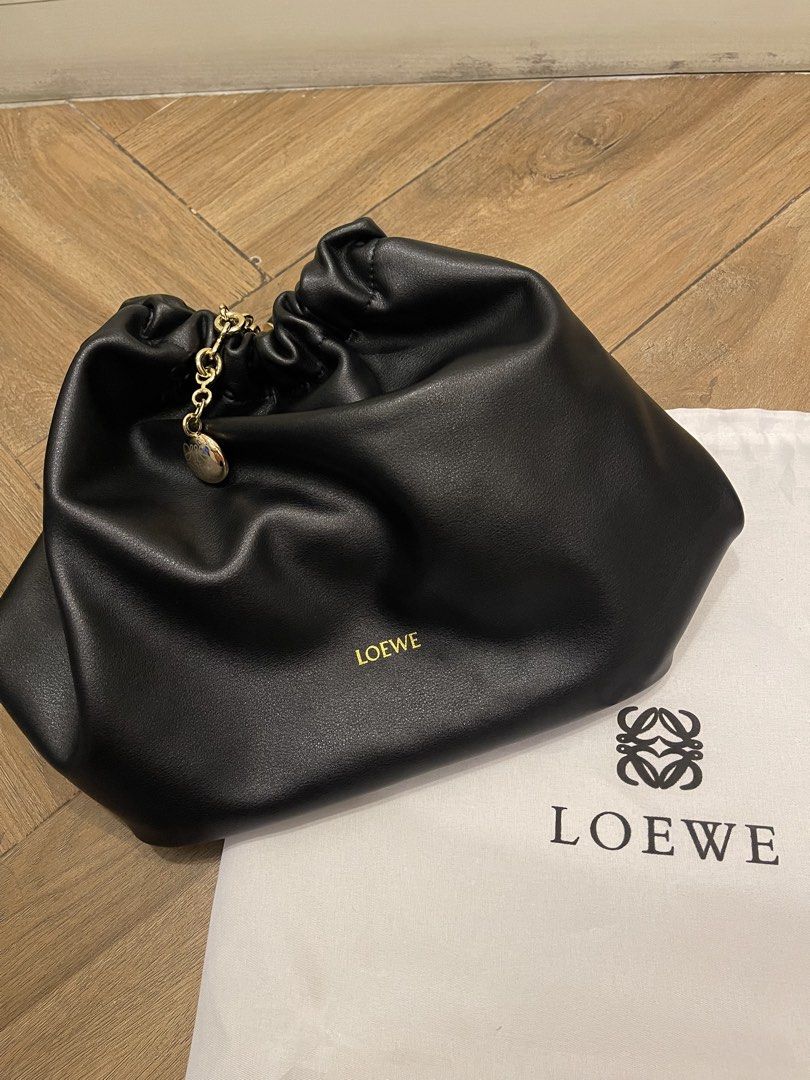 Loewe bag (Category: Luxury Bags & Wallets) located in Mandaluyong City. Submitted by soarphoenix2025 (Listing ID 1461252237, Image 2). Description: - Loewe Squeeze medium black leather shoulder bag - Elegant soft leather - Adjustable gold chain strap - Interior zip pocket for essentials - Comes with dust bag Location: Mandaluyong Payment via gcash or BPI.