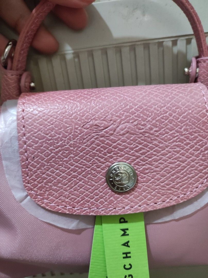 Longchamp Le Pliage Cuir Mini Top Handle Bag Pink (Category: Luxury Bags & Wallets) located in Marikina City. Submitted by kylacastillo03 (Listing ID 1461238614, Image 2). Description: - Original pink/rose Longchamp mini bag - Money back Guaranteed if prover fake - Zipper closure with snap button flap - Small size, ideal for essentials - Detachable strap included.