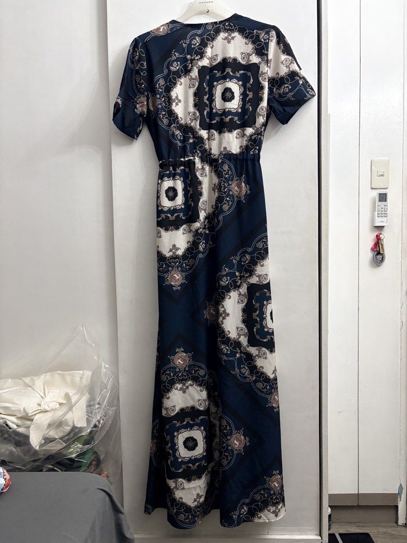 Lorraine Navy Blue Patterned Maxi Dress Size 10 (Category: Dresses) located in Quezon City. Submitted by thebutingthings (Listing ID 1461267443, Image 3). Description: - Navy blue maxi dress - Cool patterned print - Short sleeves - Drawstring waist for a flattering fit - Zip-up front closure - Convenient side pockets - Versatile for casual outings or dressing up.