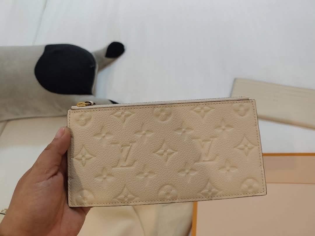 Louis Vuitton Monogram Empreinte Wallet Pouch Card Holder Set (Category: Luxury Bags & Wallets) located in Manila. Submitted by lumangukay (Listing ID 1461143576, Image 2). Description: - Authentic Louis Vuitton Set - Color: Cream/Beige - Includes: Envelope Wallet with Chain, Zip Pouch, Card Holder - Pattern: Embossed Monogram Empreinte - Comes with: Dust Bag - Ideal for: Organizing essentials or as a gift.