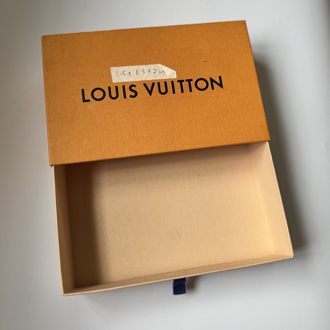 Louis Vuitton Orange Box (Category: Luxury Bags & Wallets) located in Santa Rosa. Submitted by le_classique (Listing ID 1461200152, Image 3). Description: - Authentic Louis Vuitton box - Vibrant orange exterior with classic black Louis Vuitton lettering - Light tan interior - Comes with a small information card - Dimensions are marked on the lid - Ideal for storing small valuables or as a luxurious gift box.