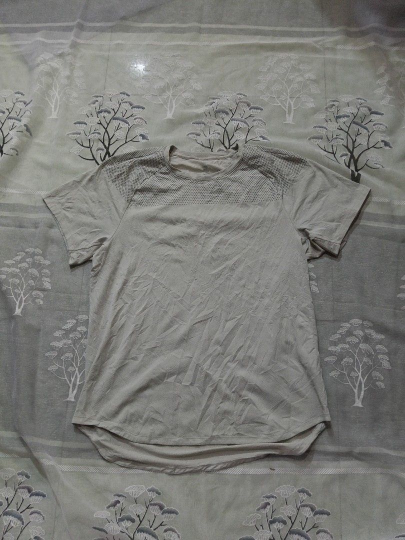 Lululemon T-Shirt XL Light Grey Athletic Top (Category: Tshirts & Polo Shirts ) located in Lingayen. Submitted by rahzzelula73279 (Listing ID 1461287913, Image 1). Description: - Brand: Lululemon - Color: Light Grey - Size: XL - Style: Athletic T-shirt - Neckline: Crew Neck - Sleeves: Short Sleeves - Features: Textured fabric on shoulders and upper chest, small logo detail on back near collar and on sleeve - Ideal for: Workouts, casual wear .