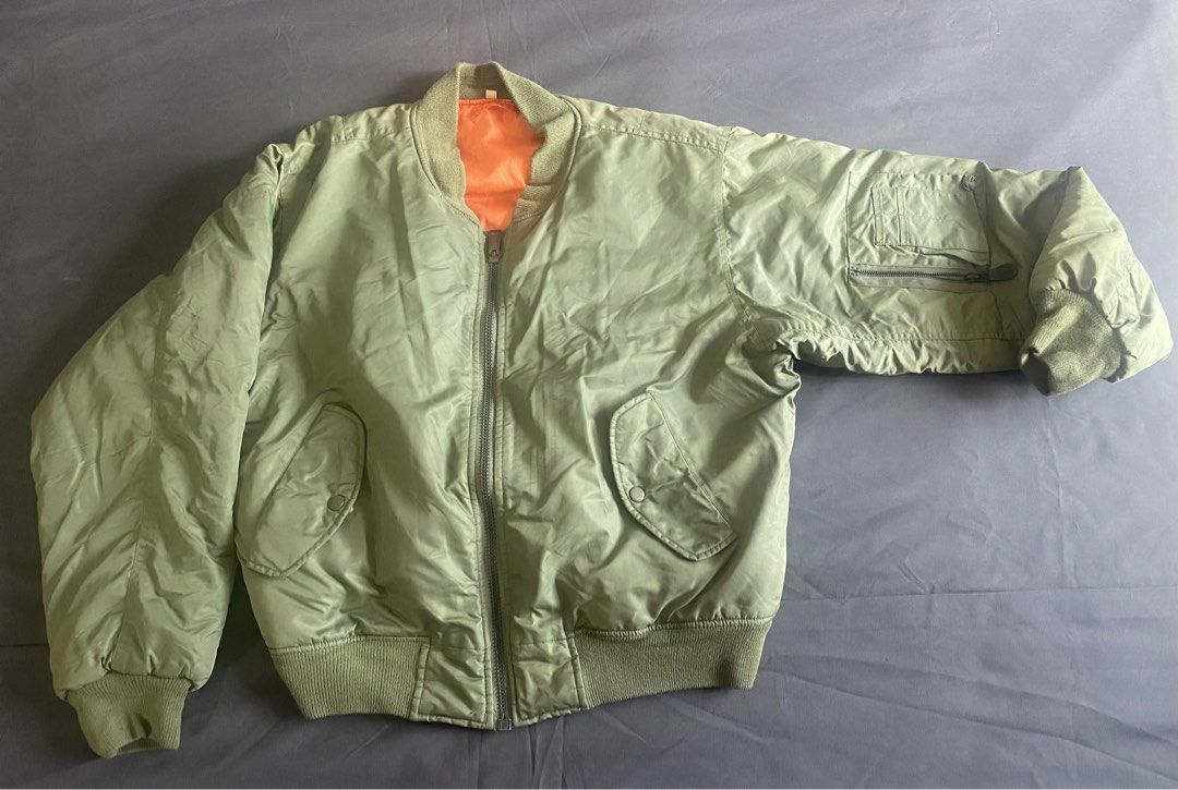 MA-1 Bomber Jacket Orange Reversible (Category: Coats, Jackets and Outerwear) located in Paranaque City. Submitted by axie1206 (Listing ID 1461267710, Image 1). Description: - Classic MA-1 bomber jacket style - Reversible design: Olive green on one side, bright orange on the other - Full zipper closure - Two front pockets with secure snap button closures - Convenient zippered pocket on the sleeve - Ribbed cuffs and hem for a snug fit - Ideal for 