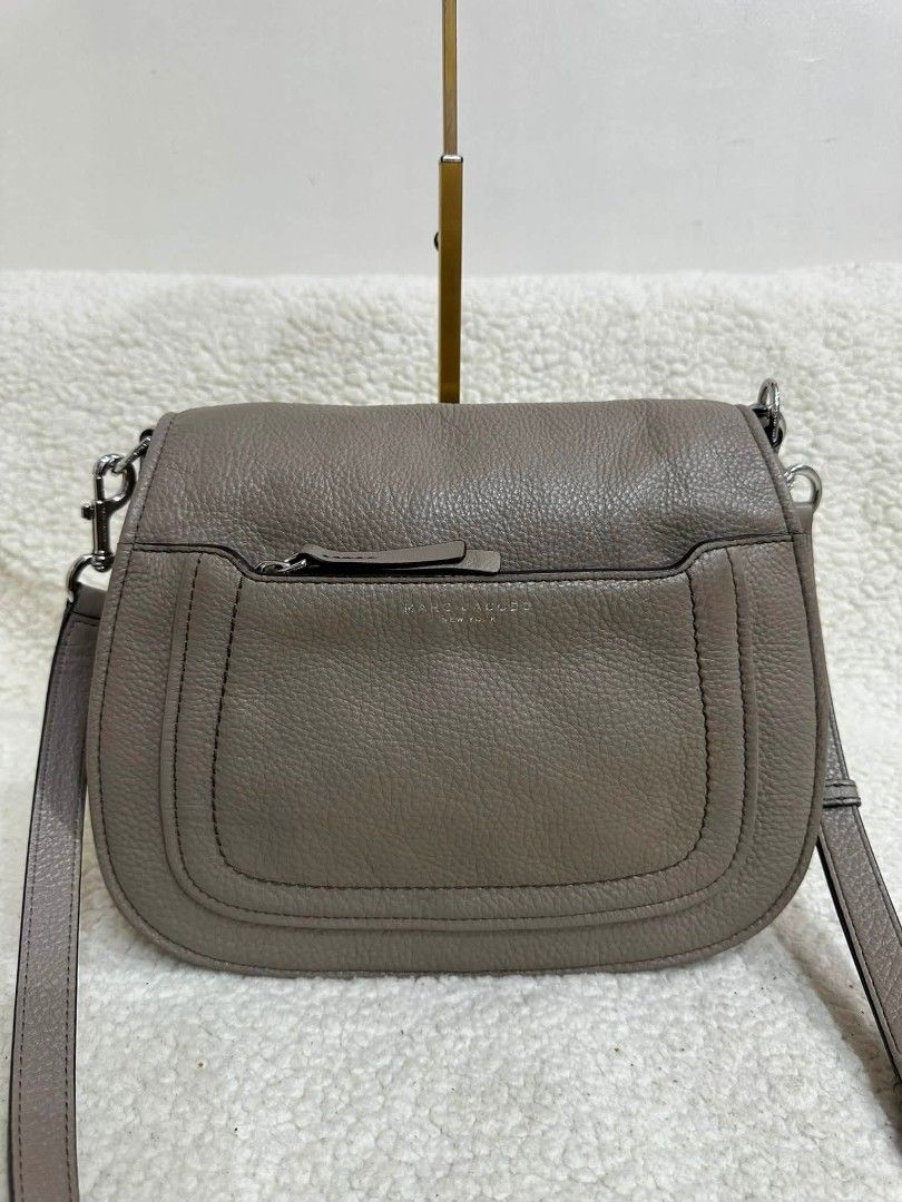 Marc Jacobs Leather Crossbody Bag Taupe (Category: Luxury Bags & Wallets) located in Rizal. Submitted by nads_a_m (Listing ID 1461146880, Image 2). Description: - Authentic Marc Jacobs crossbody bag - Color: Taupe - Material: Genuine Leather - Features: Front zip pocket, main compartment - Strap: Adjustable with buckle - Hardware: Silver - Origin: Made in New York - Style: Classic, perfect for everyday use.