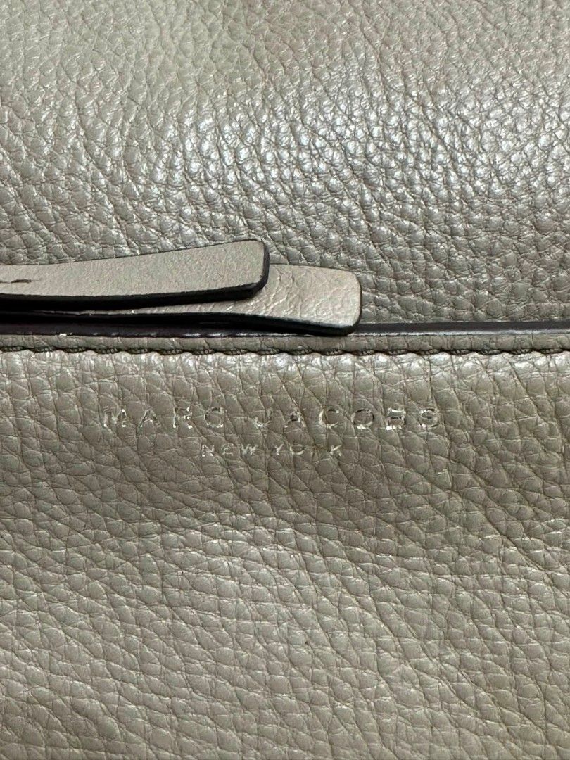 Marc Jacobs Leather Crossbody Bag Taupe (Category: Luxury Bags & Wallets) located in Rizal. Submitted by nads_a_m (Listing ID 1461146880, Image 3). Description: - Authentic Marc Jacobs crossbody bag - Color: Taupe - Material: Genuine Leather - Features: Front zip pocket, main compartment - Strap: Adjustable with buckle - Hardware: Silver - Origin: Made in New York - Style: Classic, perfect for everyday use.