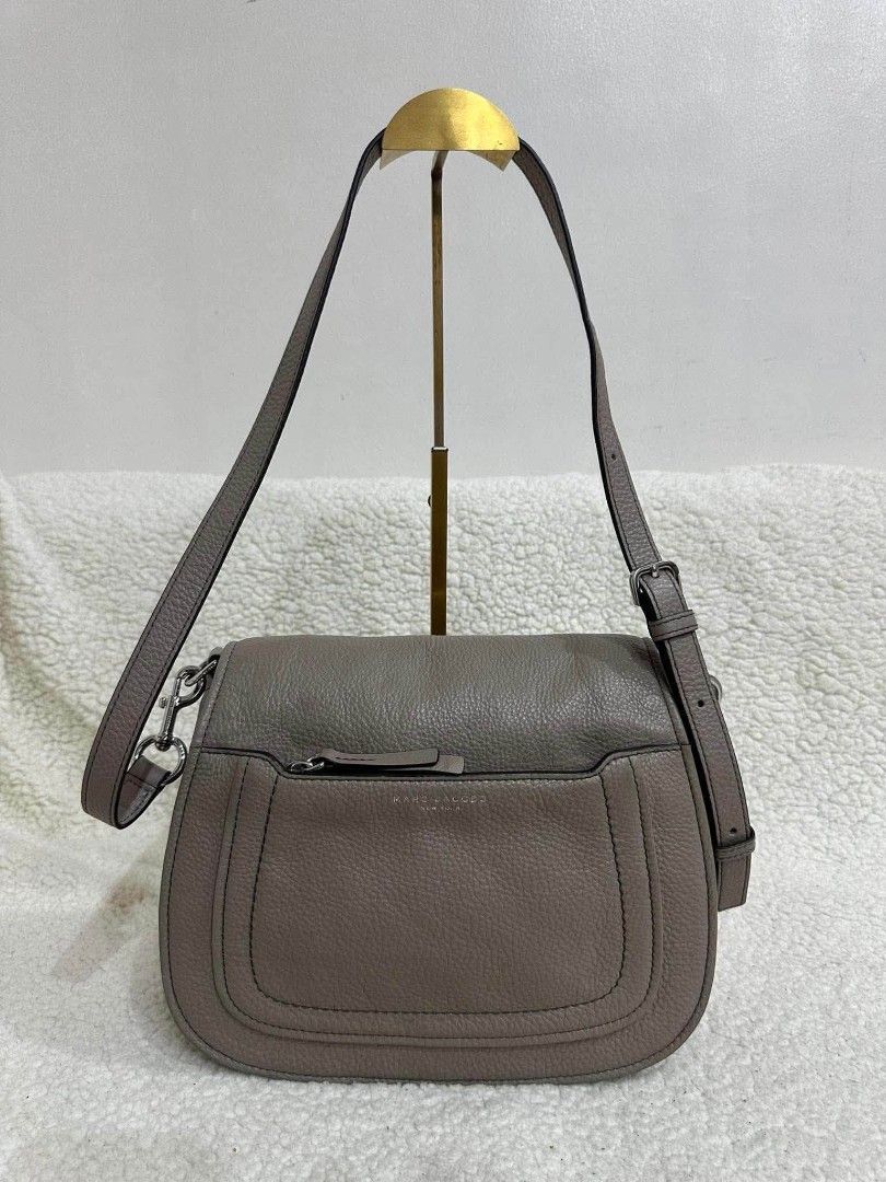 Marc Jacobs Leather Crossbody Bag Taupe (Category: Luxury Bags & Wallets) located in Rizal. Submitted by nads_a_m (Listing ID 1461146880, Image 1). Description: - Authentic Marc Jacobs crossbody bag - Color: Taupe - Material: Genuine Leather - Features: Front zip pocket, main compartment - Strap: Adjustable with buckle - Hardware: Silver - Origin: Made in New York - Style: Classic, perfect for everyday use.