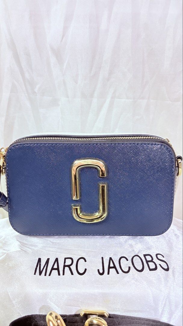 Marc Jacobs Snapshot Camera Bag Navy Blue Gold Hardware (Category: Cross-body Bags) located in Pateros City. Submitted by marifernandez (Listing ID 1461215351, Image 2). Description: - High Quality only - Navy blue Marc Jacobs Snapshot bag - Iconic gold double J logo - Detachable strap with bold lettering - Zipper closure - Interior zip pocket - Ideal for everyday use.