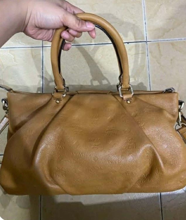 MCM Monogram Leather Tote Bag (Category: Luxury Bags & Wallets) located in Manila. Submitted by boldfire_315559 (Listing ID 1461234422, Image 2). Description: - Brown MCM tote bag - All-over monogram print - Genuine leather material - Features two top handles - Perfect for everyday use.