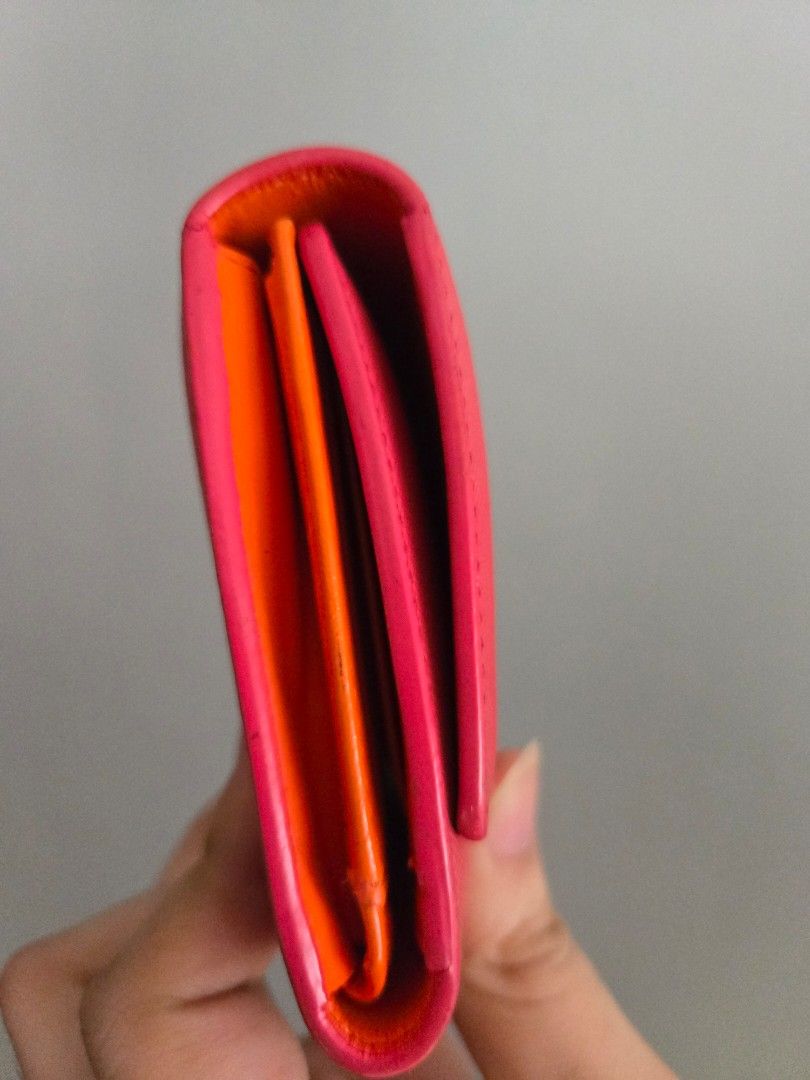 MCM Pink Leather Long Wallet (Category: Luxury Bags & Wallets) located in Rizal. Submitted by nads_a_m (Listing ID 1461147170, Image 2). Description: - Pink MCM long wallet - Durable saffiano leather exterior - Signature gold MCM logo hardware - Striking bright orange interior - Numerous card slots for organization - Spacious compartment for cash - Classic and functional design.