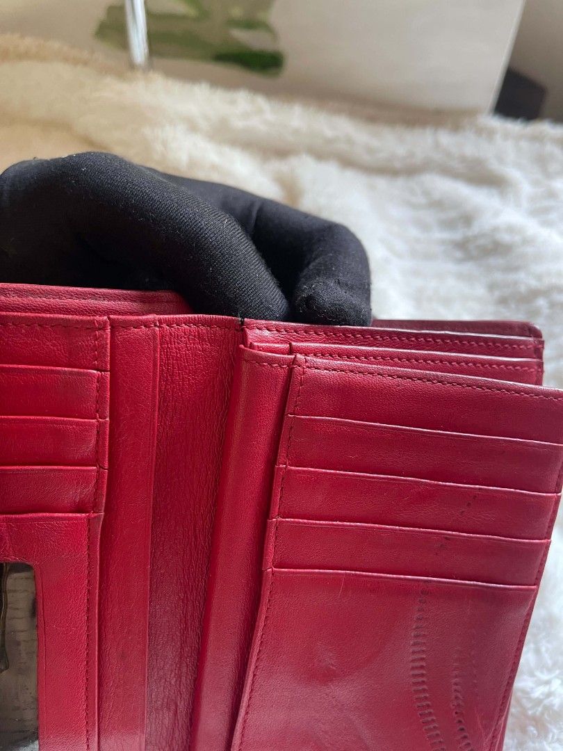 METROCITY Red Leather Wallet with Gold M Logo (Category: Wallets & Card holders) located in Naawan. Submitted by twilly.apparel2 (Listing ID 1461151233, Image 3). Description: -issue hardware hairline, may crack leather, pressed mark Genuine red leather wallet from METROCITY - Features iconic gold 'M' logo on the front - Ample card slots and compartments for organization - Shows minor signs of wear on edges and corners, consistent with use - Perf