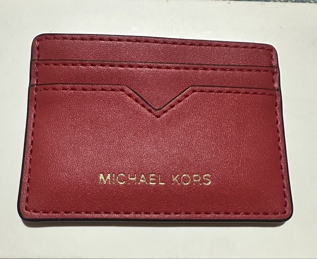 Michael Kors Red Leather Cardholder (Category: Wallets & Card holders) located in Las Pinas. Submitted by sophie1005 (Listing ID 1461223973, Image 1). Description: - Genuine red leather cardholder by Michael Kors - Multiple slots for easy card organization - Elegant gold lettering detail on the front - Simple, chic, and practical design.
