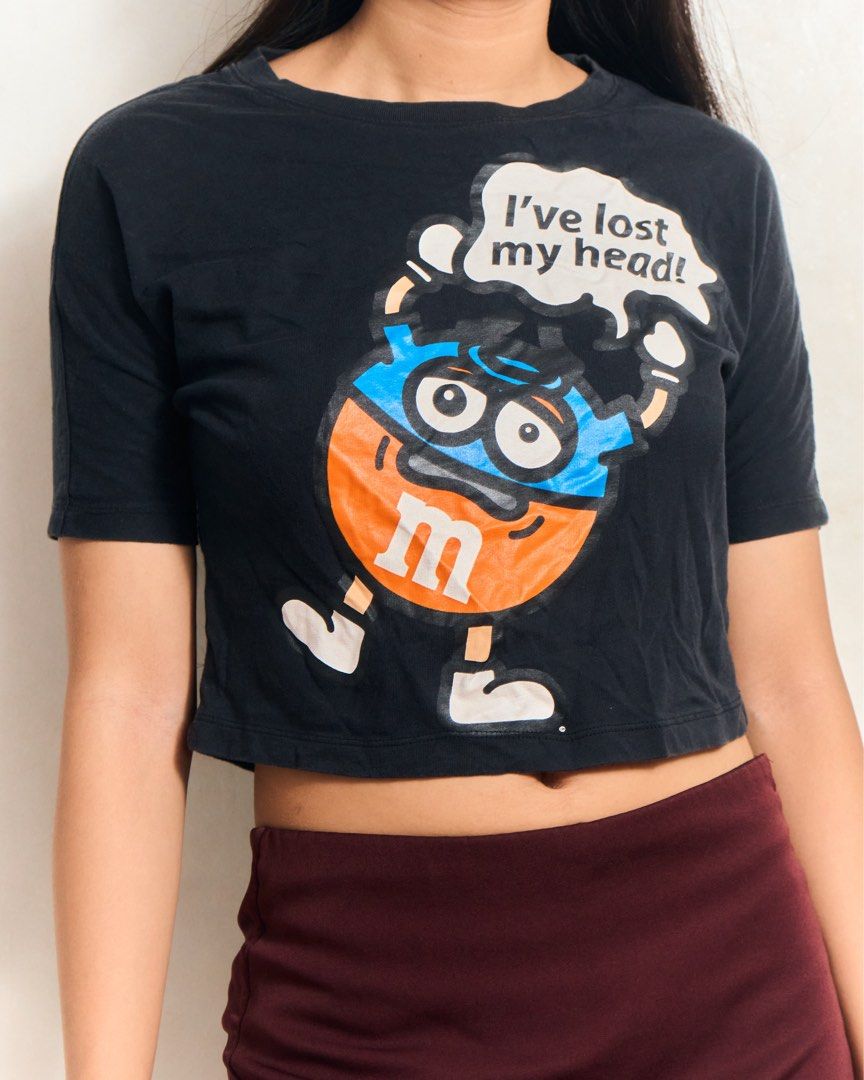 M&M's Bossini Graphic Crop Top (Category: Shirts) located in Manila. Submitted by missalmon (Listing ID 1461254583, Image 1). Description: L: 16 inches W: 19 inches Cropped Slim Fit Issue: Slightly Bacon Neck .