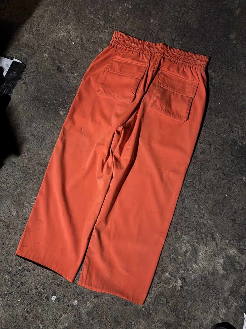 MODITEC Orange Cargo Pants Elastic Waist (Category: Other Bottoms) located in Pasig City. Submitted by dripthrift1600 (Listing ID 1461258340, Image 2). Description: - Orange cargo pants from MODITEC - Comfortable elastic waistband - Two back pockets with button closures - Relaxed fit with a wide leg - Ideal for casual everyday wear - Excellent Condition - No Issue - Need wash - Dimes: 32x38x9 #dripthrift1600.