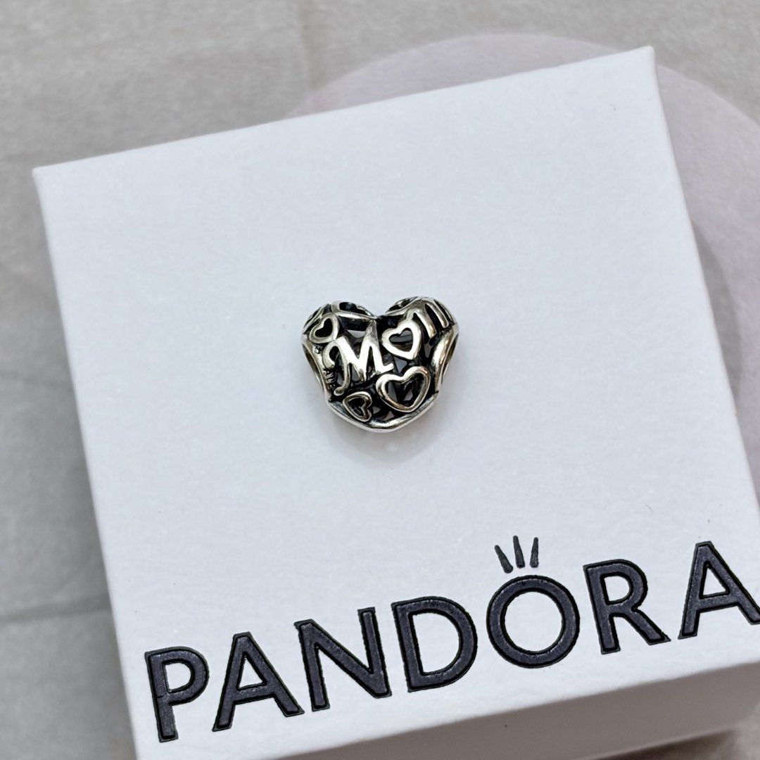 Mom Openwork Charm (RETIRED) (Category: Charms) located in Makati City. Submitted by charmedby.jo (Listing ID 1461247701, Image 1). Description: - authentic, retired Pandora charm w/ 925 ALE mark - preloved, excellent condition - lifetime free cleaning at Pandora branches - recently cleaned at 6750 Ayala Pandora Care Center (pm for receipt/proof) Retired Sterling Silver Motherly Love Openwork Family Charm - 791519.