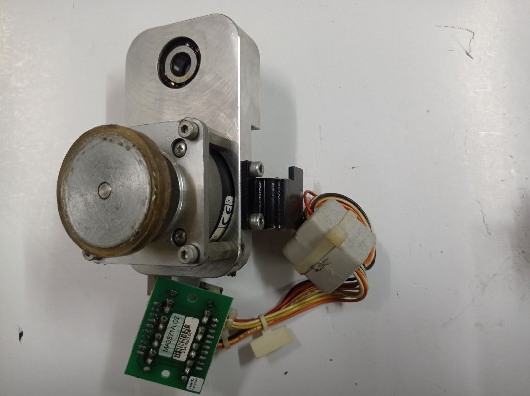 Motorized Roller Pulley Assembly MA3571A.0Z - Durst Theta (Category: Cardio & Fitness Machines) located in Caloocan City. Submitted by agolito (Listing ID 1461243828, Image 1). Description: Original motorized roller or pulley assembly removed from a Durst Theta machine. PCB marking: MA3571A.0Z Motor marking: Made in Italy; complete model is not visible Includes: • Electric motor • Large drive or transport wheel • Aluminum mounting bracket • Beari