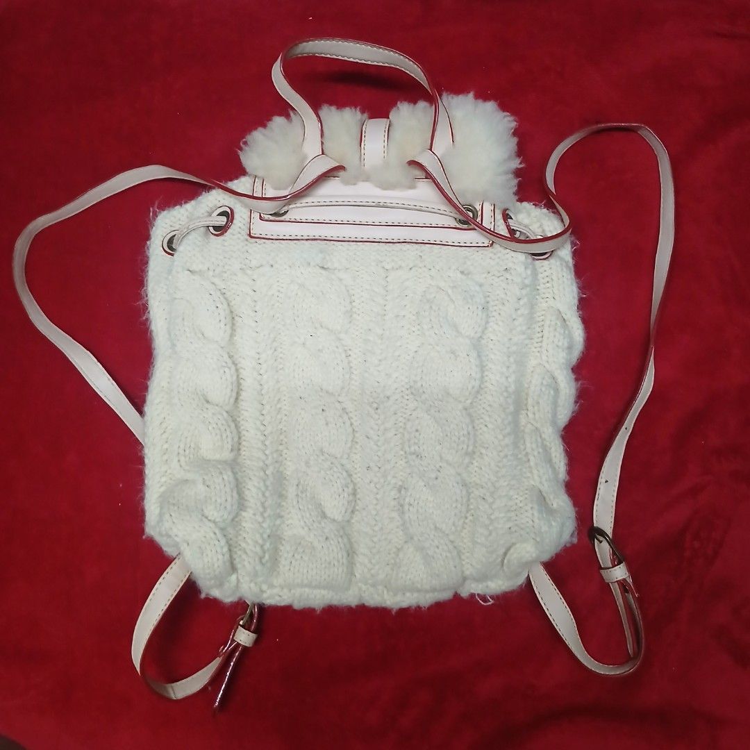 MUKU Knit & Shearling Mini Backpack (Category: Backpacks) located in Cagayan de Oro. Submitted by susanthrifts (Listing ID 1461246011, Image 2). Description: ​Brand: muku (Made in Japan) ​Item: Cable-knit & shearling drawstring mini backpack ​Color: Cream / Off-white (beige straps) ​Design Details: Real shearling front flap with buckle, thick cable-knit body, side drawstring tassels, adjustable thin straps. Super cute aesthetic for winter/cozy ou
